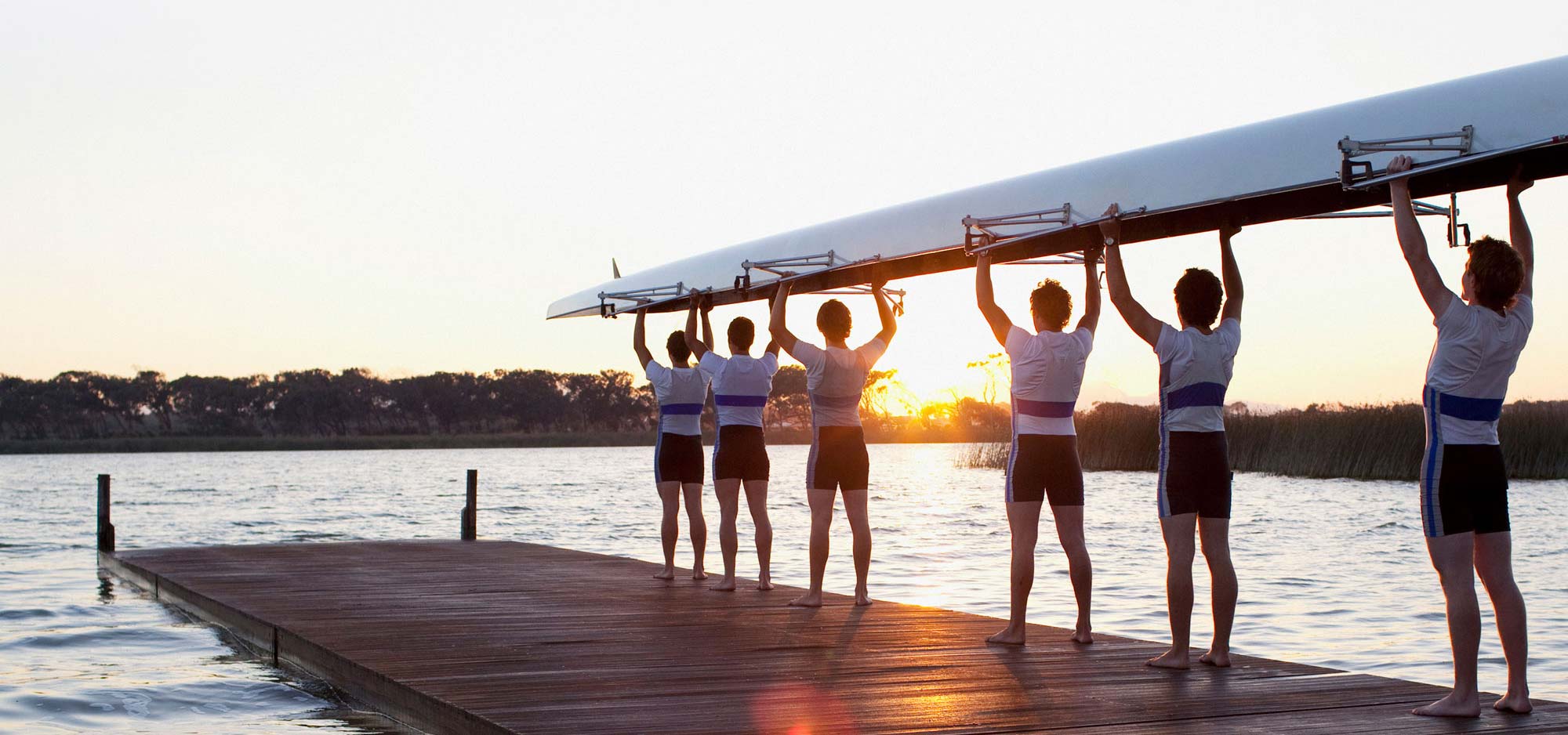 rowers holding up boat