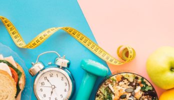 An image of random objects including tape measure, a clock, a sandwich and fruit.