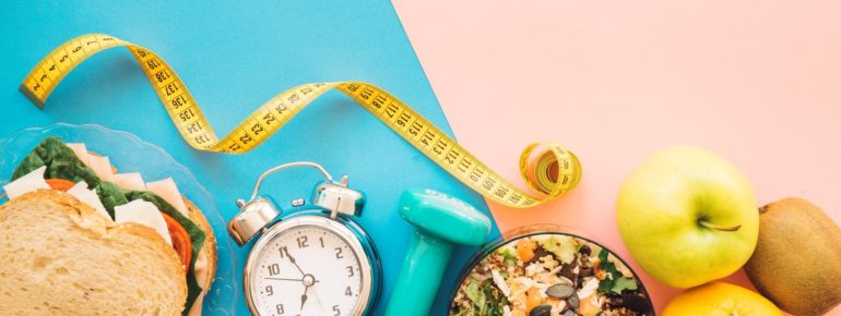 An image of random objects including tape measure, a clock, a sandwich and fruit.