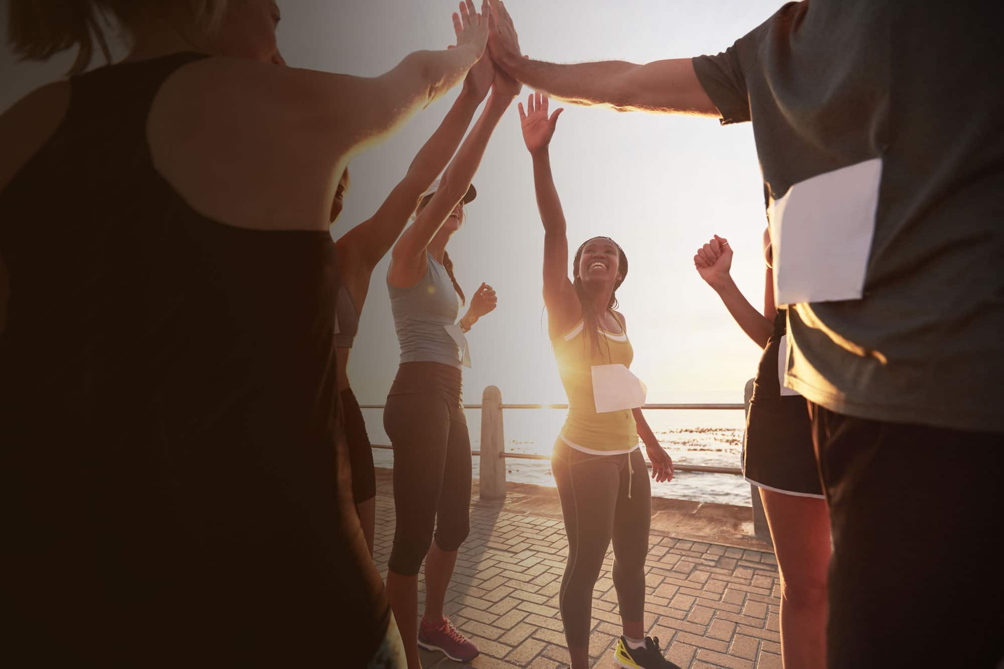 A group of runners high fiving.