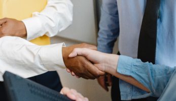 An image of employees shaking hands.