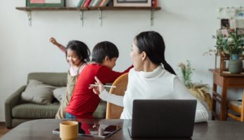 Mom turned around from work to yell at children.