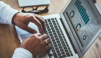 Employee hands typing on laptop