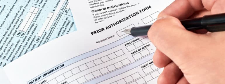 image: Person filling out a "Prior Authorization Form"